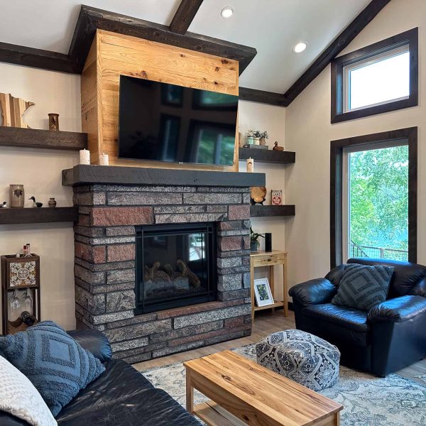 Schaefbauer home on Munson Lake living room with fireplace and lakeside patio doors closeup