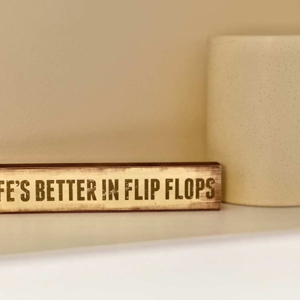 Bossert Home on Lake Lida • Life's Better in Flip Flops sign on the closet shelf