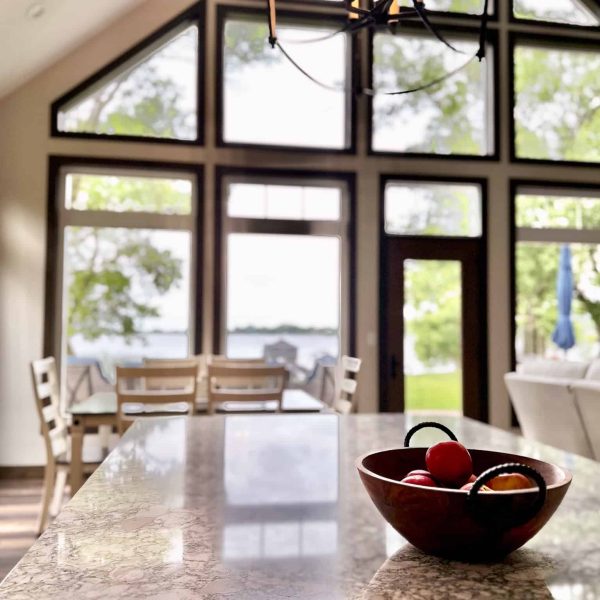 Bossert Home on Lake Lida • bowl of apples on kitchen island counter looking outward toward lake