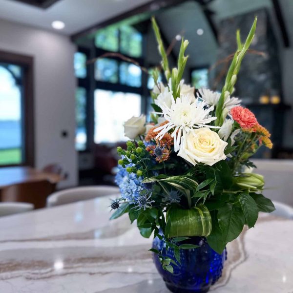 Spicer Home on Pelican Lake • marble island countertop with flowers • living room area in background
