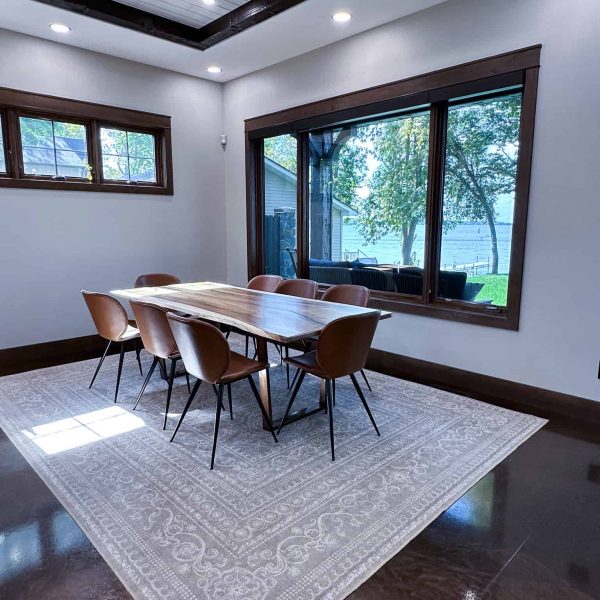 Spicer Home on Pelican Lake • wood dining room table with view of the lake through a large picture window