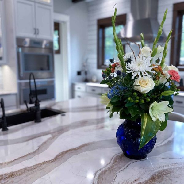 Spicer Home on Pelican Lake • marble island countertop with flowers • oven and cabinets in the background