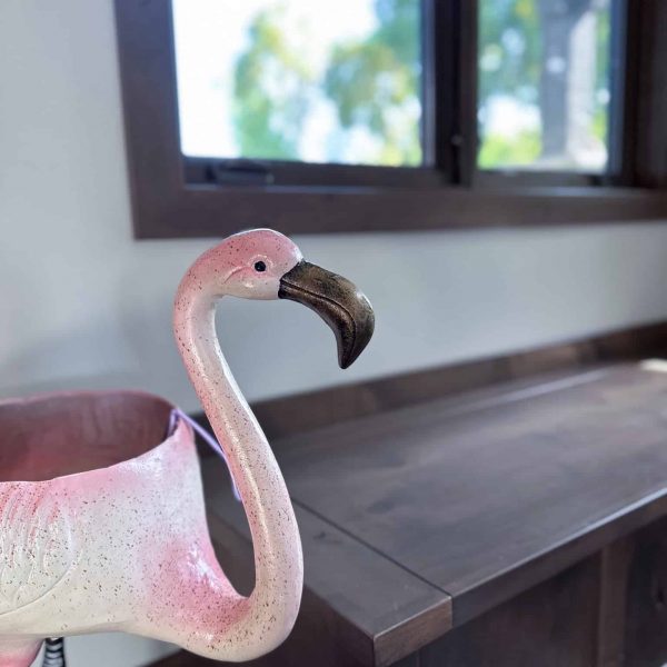 Spicer Home on Pelican Lake • Entryway flamingo statue next to a wooden built-in bench