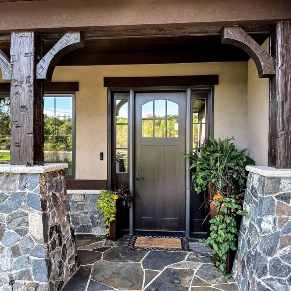 Spicer Home on Pelican Lake • Exterior roadside door with rock pillars