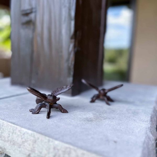 Spicer Home on Pelican Lake • Exterior pillars with firefly figures on the surface of pillar mantel