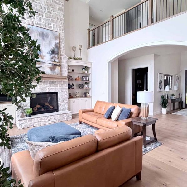 Modern living room with high ceilings, fireplace, and cozy seating area.