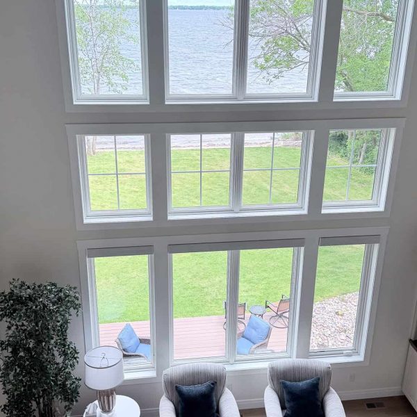 Spacious living room with floor-to-ceiling windows overlooking Detroit Lake.