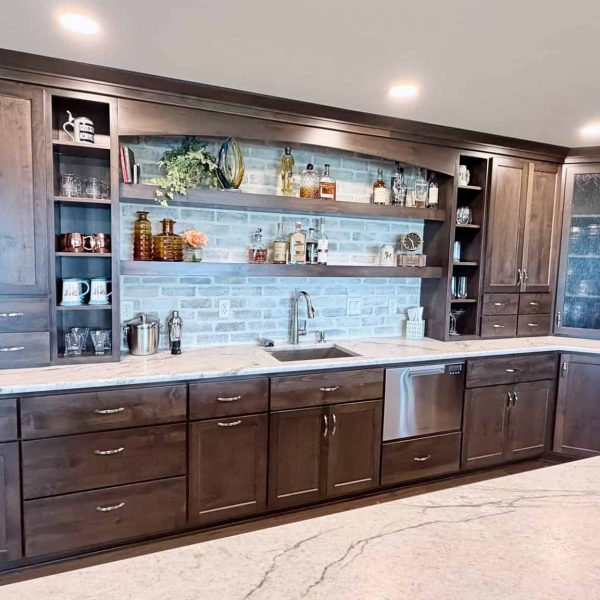 Elegant dark wood kitchen cabinets with open shelving and wine storage.
