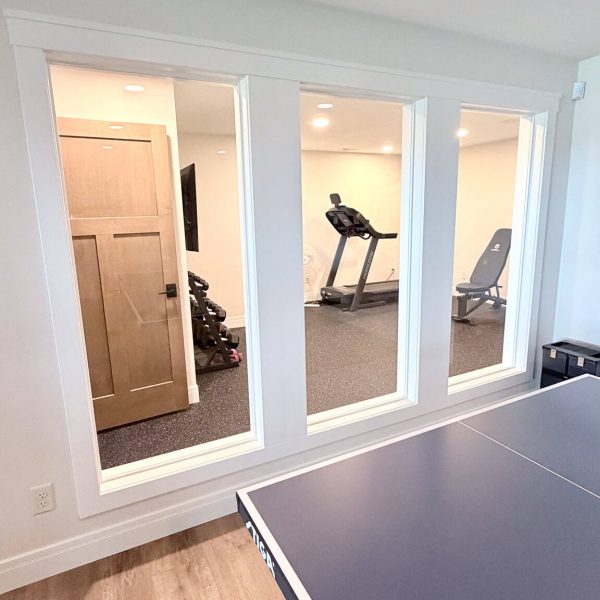 Recreation room with ping pong table, treadmill, and lounge chair.