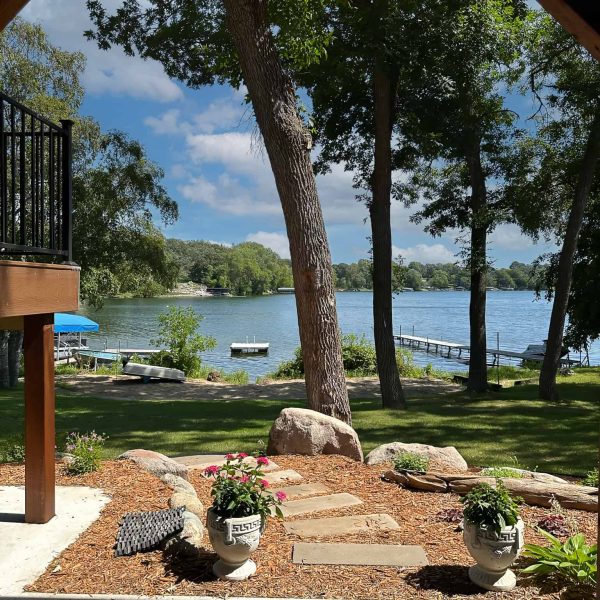 Schaefbauer home on Munson Lake walkout basement view with stepping stone pathway to the lake