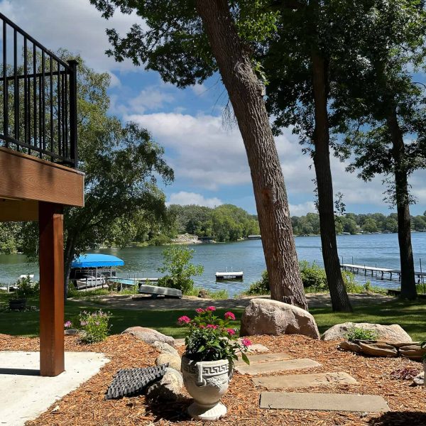 Schaefbauer home on Munson Lake walkout basement view with stepping stone pathway to the lake